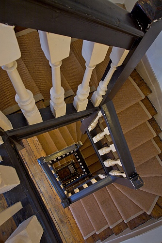 View of the open staircase at Dr Johnson's House, taken from the top floor towards the ground floor.